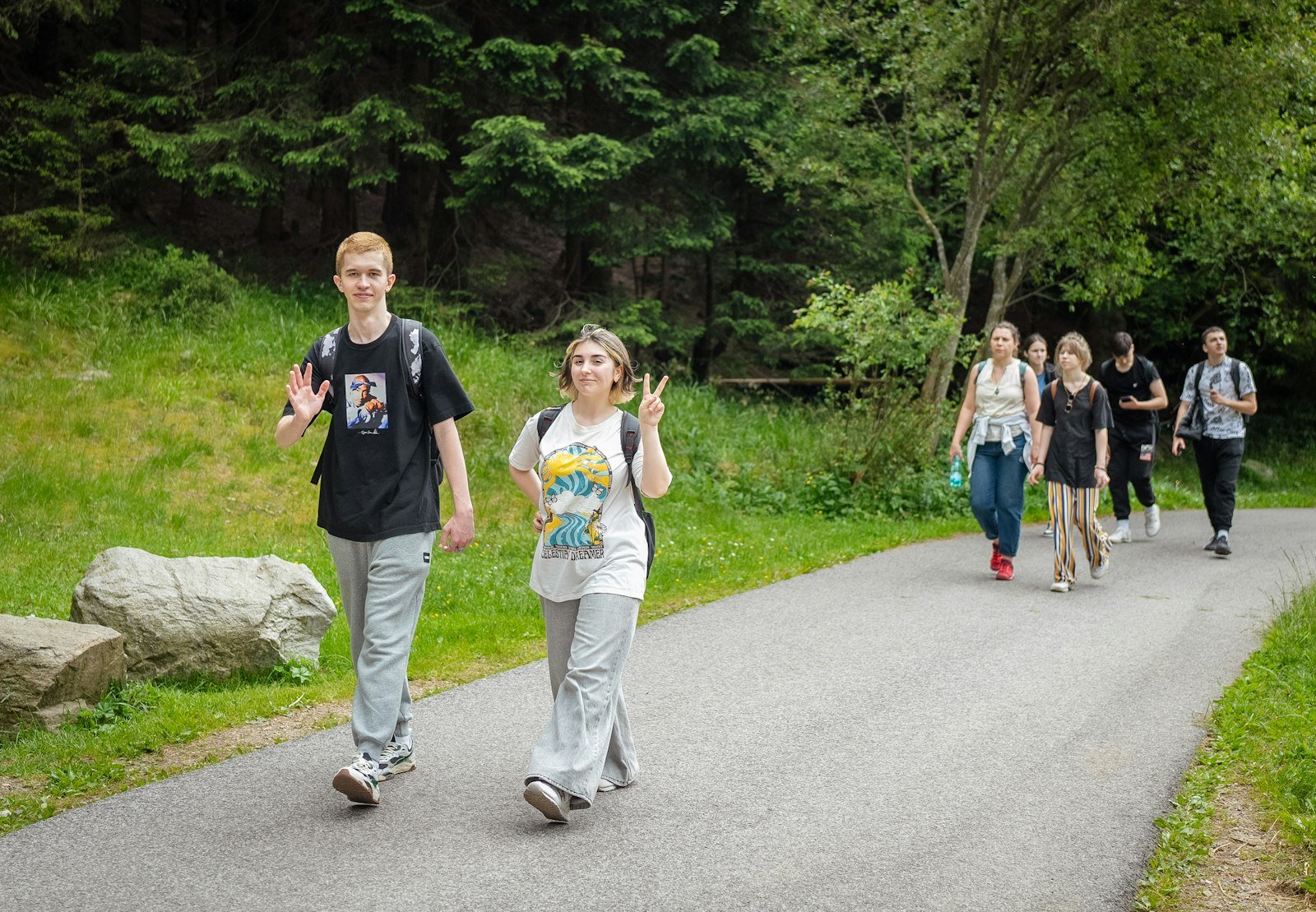 Young hikers walking together towards a rustic mountain lodge at golden hour