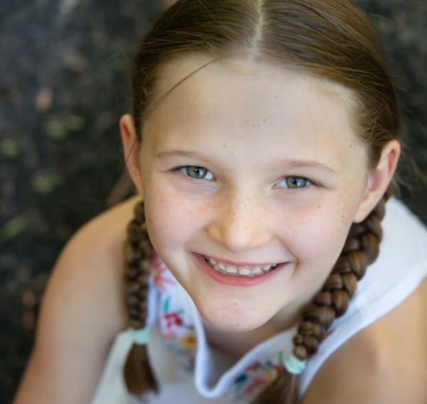 Portrait of a young person with braids, smiling