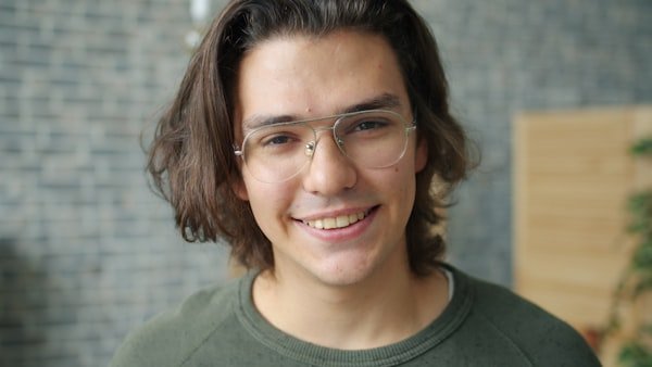 Portrait of a young man with glasses smiling